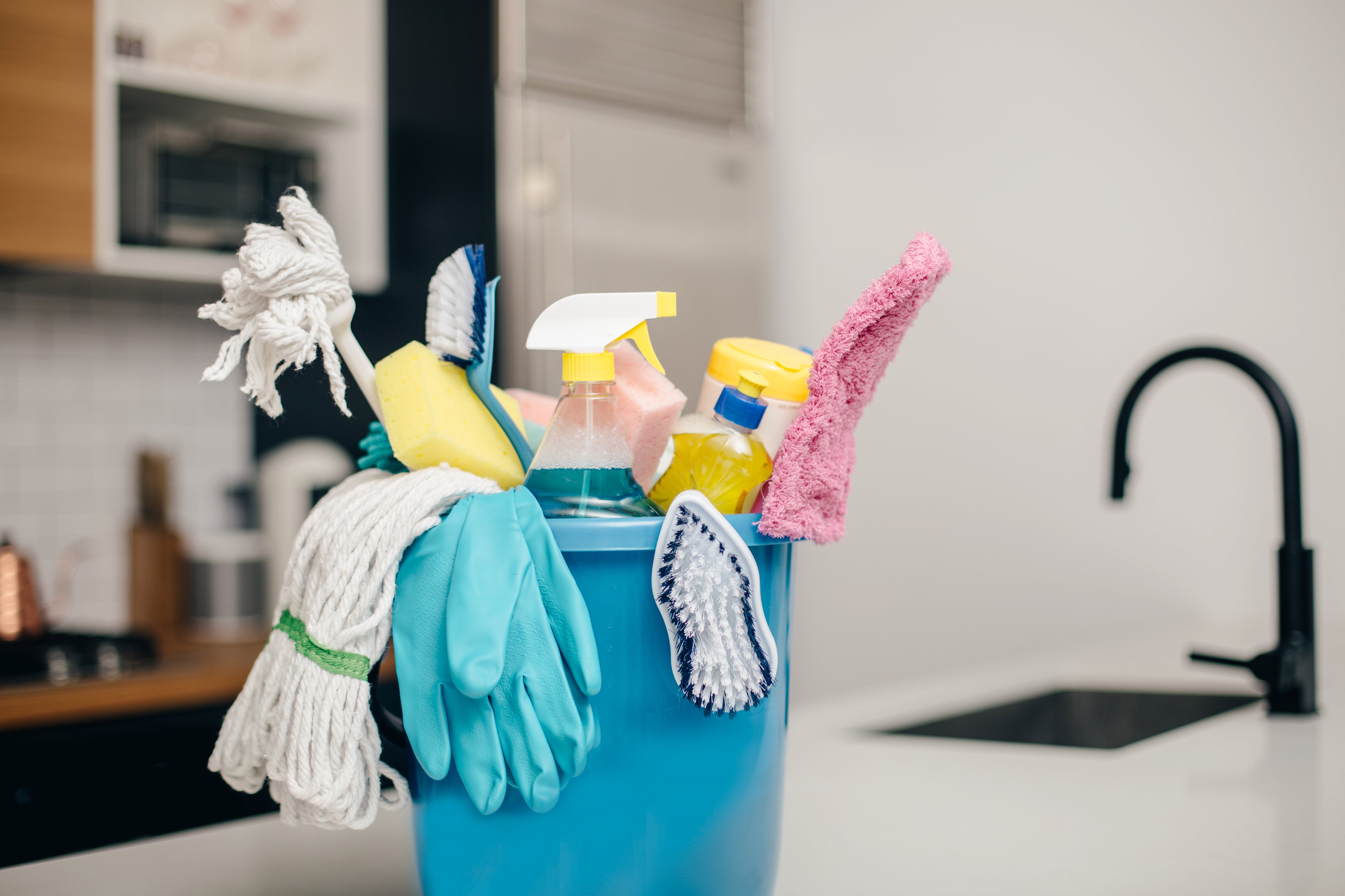 cleaning supplies bucket in clean work kitchen