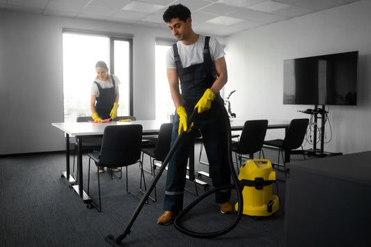 Office carpet cleaning services team vacuuming carpets and wiping desks in a clean workspace
