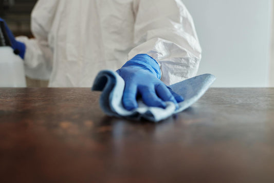 Janitor wiping a conference table during office cleaning Reno service to maintain a clean, professional workspace